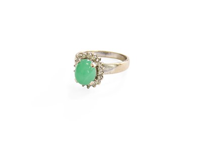 Lot 127 - A Green Stone and Diamond Cluster Ring, the...