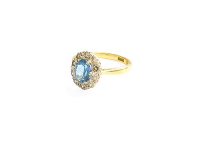 Lot 32 - A Blue Topaz and Diamond Cluster Ring, the...