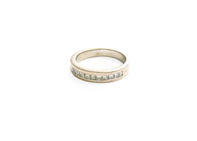 Lot 152 - A Diamond Half Hoop Ring, the princess cut...