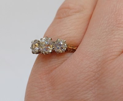 Lot 2277 - A Diamond Three Stone Ring the graduated old...