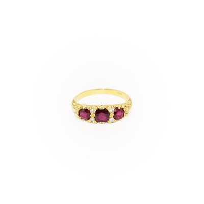 Lot 254 - A Red Stone and Diamond Ring, three cushion...