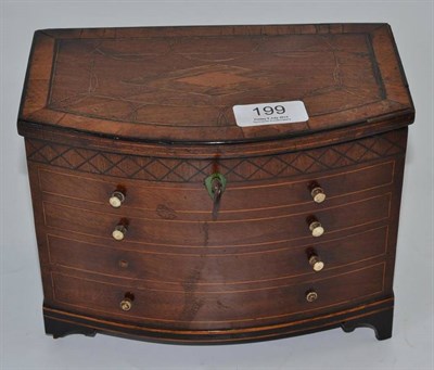 Lot 199 - A 19th century novelty tea caddy modelled as a bow fronted chest of drawers with parquetry...