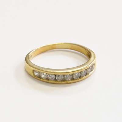 Lot 234 - A Diamond Half Hoop Ring, nine round brilliant...