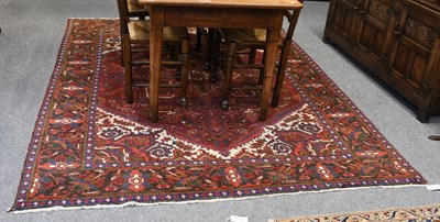 Lot 1073 - Heriz Carpet, the deep blood red field with...