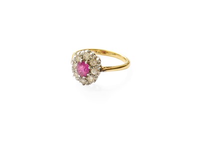 Lot 425 - A Pink Sapphire and Diamond Cluster Ring, the...