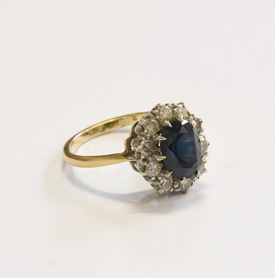 Lot 237 - A Sapphire and Diamond Cluster Ring, the oval...