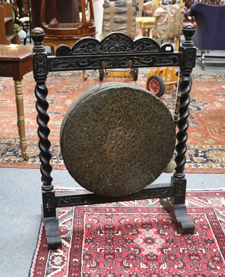 Lot 1461 - A Dinner Gong, within a carved oak frame on...