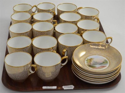 Lot 246 - A 19th century part tea service with gilt seaweed decoration, the saucers painted with a landscape