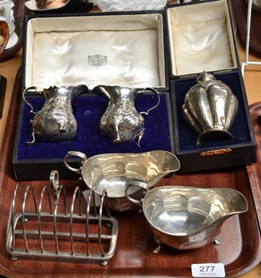 Lot 277 - A pair of 20th century silver sauce boats, two Georgian silver cream helmets (very worn marks)...