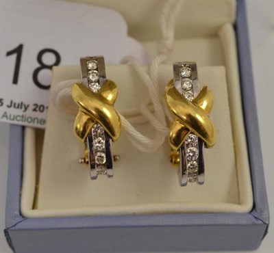 Lot 318 - A pair of diamond cuff earrings, round brilliant cut diamonds in a white channel settings, overlaid