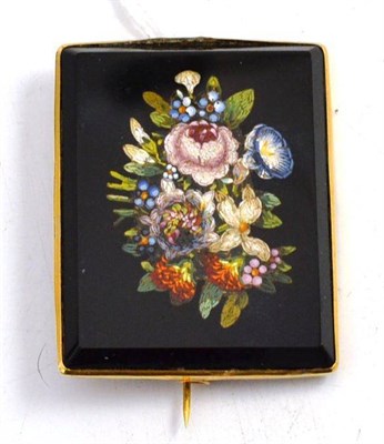 Lot 321 - A micro-mosaic brooch, the black ground with a scene of flowers and foliage, in an unmarked...