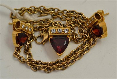 Lot 326 - An 18ct gold garnet and white stone pendant on chain, a trilliant cut garnet in a yellow claw...