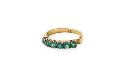 Lot 456 - An Emerald Six Stone Ring, the round cut...