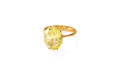 Lot 422 - A Yellow Stone Ring, the yellow oval cut stone...