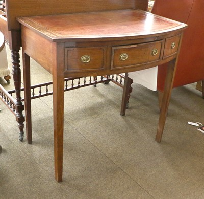 Lot 1311 - A Leather Inset Oak Writing Table, with bow front