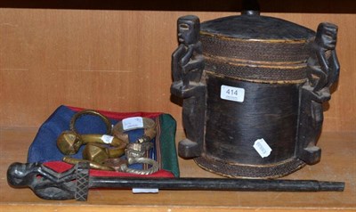 Lot 414 - A Borneo bentwood foot container and a trap guardian, eight Nigerian brass manillas