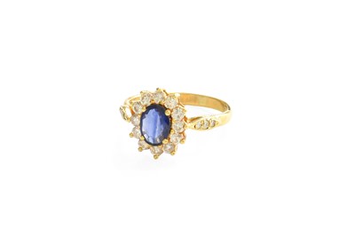 Lot 104 - A Sapphire and Diamond Cluster Ring, the oval...