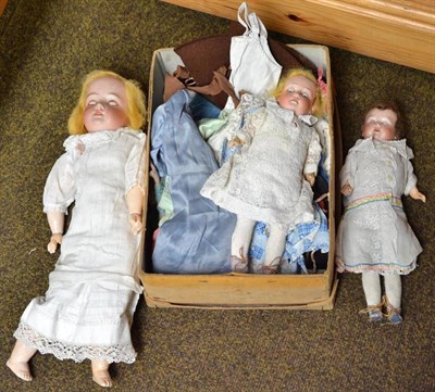 Lot 417 - An AM 930 bisque socket head doll, two smaller bisque head dolls, doll's costume etc