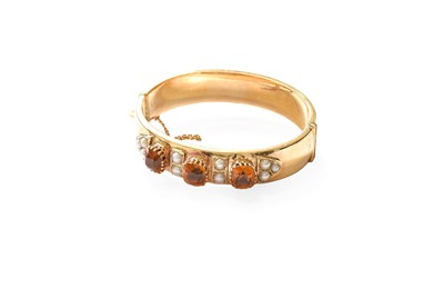 Lot 442 - A 9 Carat Gold Citrine and Split Pearl Bangle,...