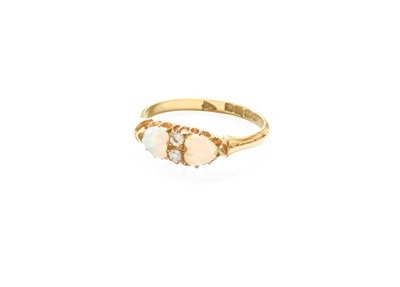 Lot 318 - An 18 Carat Gold Opal and Diamond Ring, two...