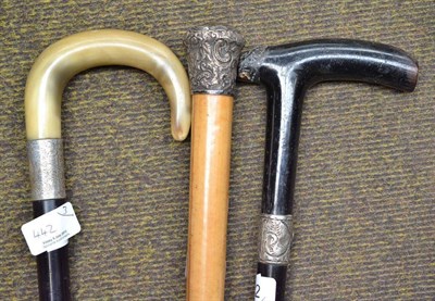 Lot 442 - A silver topped walking cane, and two others