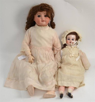 Lot 451 - A SFBJ 60 bisque socket head doll on composition jointed body and another smaller bisque socket...