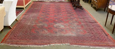 Lot 1146 - Afghan Carpet, the claret feld with three...