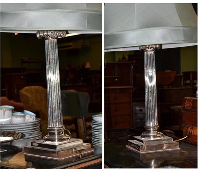 Lot 476 - A pair of silver plated ionic column table lamps