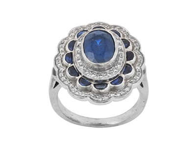 Lot 2315 - A Sapphire and Diamond Cluster Ring the oval...