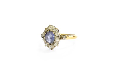 Lot 35 - A Sapphire and Diamond Cluster Ring, the oval...