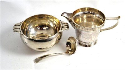 Lot 488 - A silver cream jug, sugar bowl and spoon