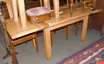 Lot 1551 - A Modern Light Oak Drawer Leaf Dining Table,...