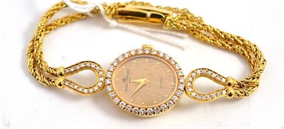 Lot 526 - Lady's gold and diamond Baume & Mercier watch