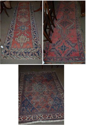 Lot 679 - North West Persian runner, the rust field with a column of stepped medallions enclosed by leaf...