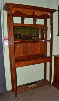 Lot 689 - An Arts and Crafts oak hall stand with mirror back and stick stand