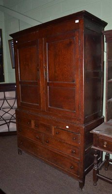 Lot 694 - An 18th century oak livery cupboard with two panel doors over an arrangement of drawers