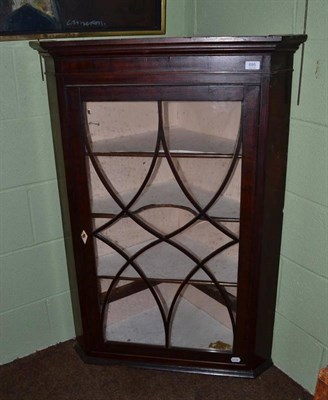 Lot 695 - A mahogany glazed corner cupboard