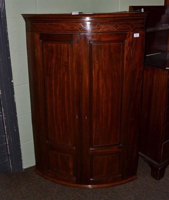 Lot 701 - A George III inlaid mahogany hanging corner cupboard