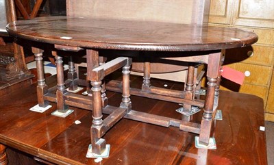 Lot 712 - A reproduction cross banded oak gate leg coffee table