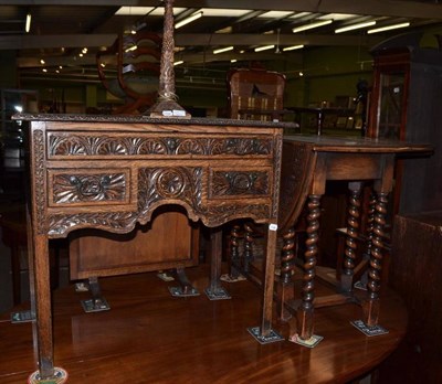 Lot 719 - A 20th century carved oak barley twist gate leg table, carved oak low boy and a carved oak...