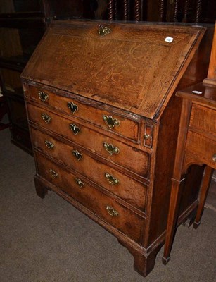 Lot 723 - A George III oak bureau desk