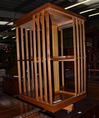 Lot 729 - A reproduction yew revolving bookcase