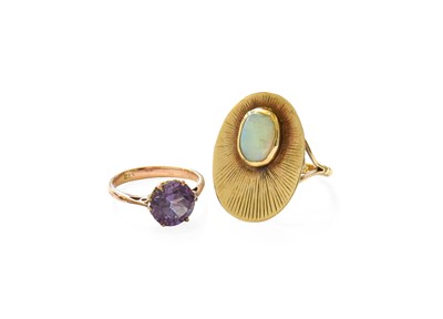 Lot 243 - An Opal Ring, the yellow textured oval plaque...