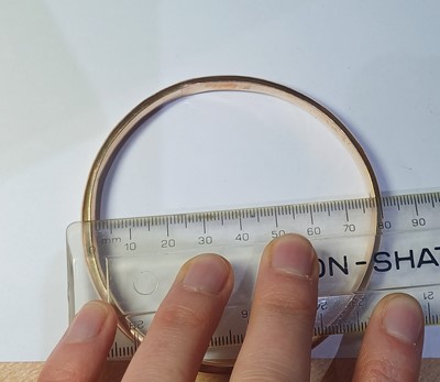 Lot 62 - A 9 Carat Gold Bangle, inner diameter 7.6cm;...