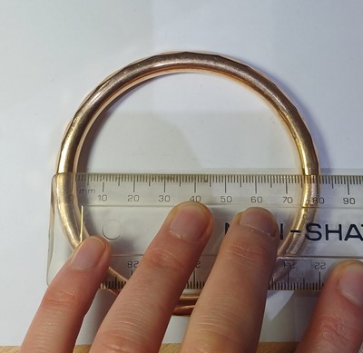 Lot 62 - A 9 Carat Gold Bangle, inner diameter 7.6cm;...