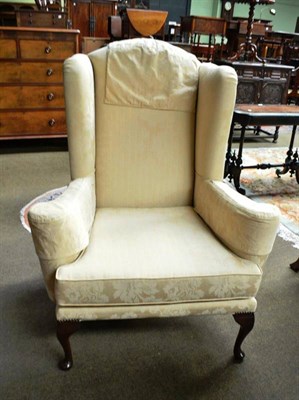 Lot 756 - A Georgian style wing back armchair with gold brocade upholstery of recent manufacture