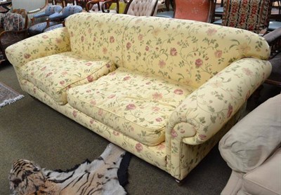 Lot 773 - A modern three seater settee with floral upholstery