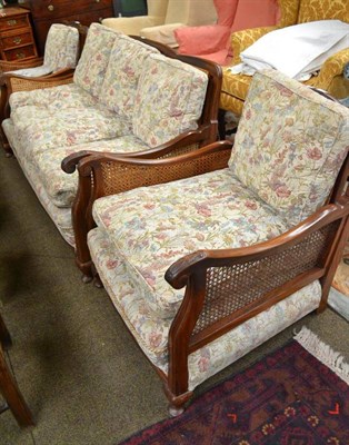 Lot 783 - A walnut framed three piece bergere suite with loose cushions