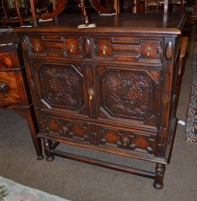 Lot 787 - A reproduction carved oak cupboard