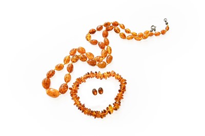 Lot 292 - A Graduated Amber Bead Necklace, length 58cm;...